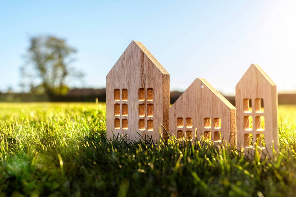 Ecological,Wood,Model,House,In,Empty,Field,At,Sunset,Concept