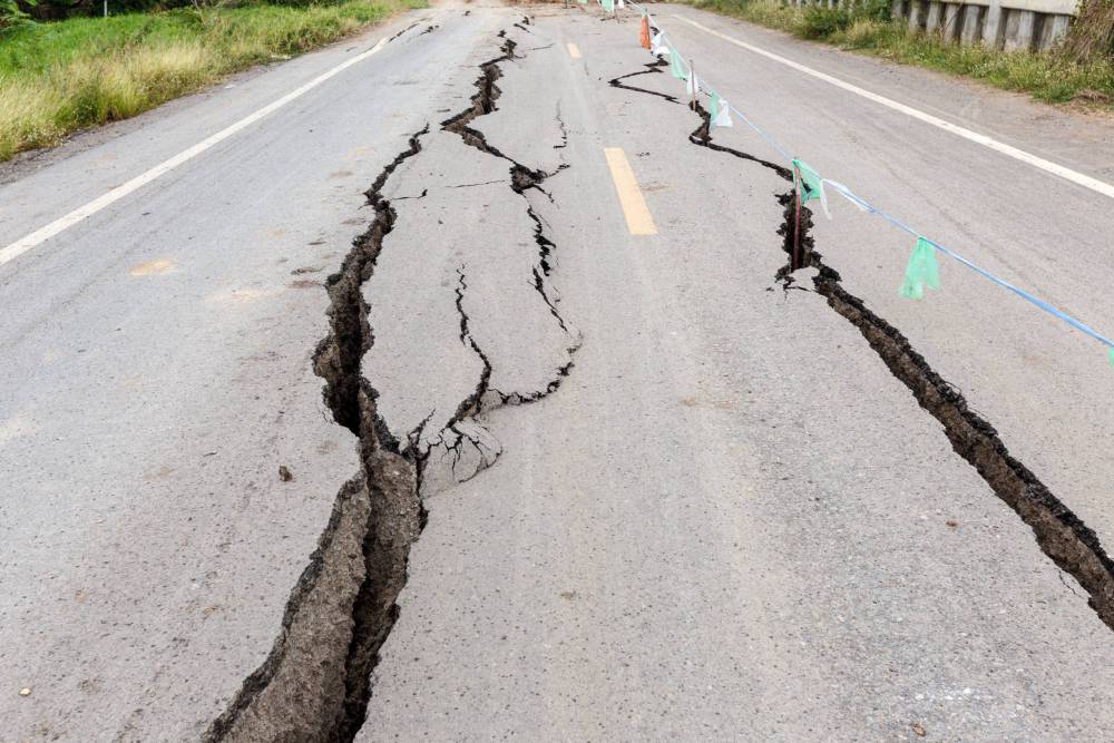 Asphalt,Road,Cracked,And,Broken,From,Earthquake.
